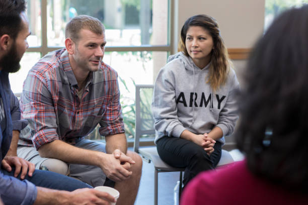 Veterans seated in a group therapy conversation